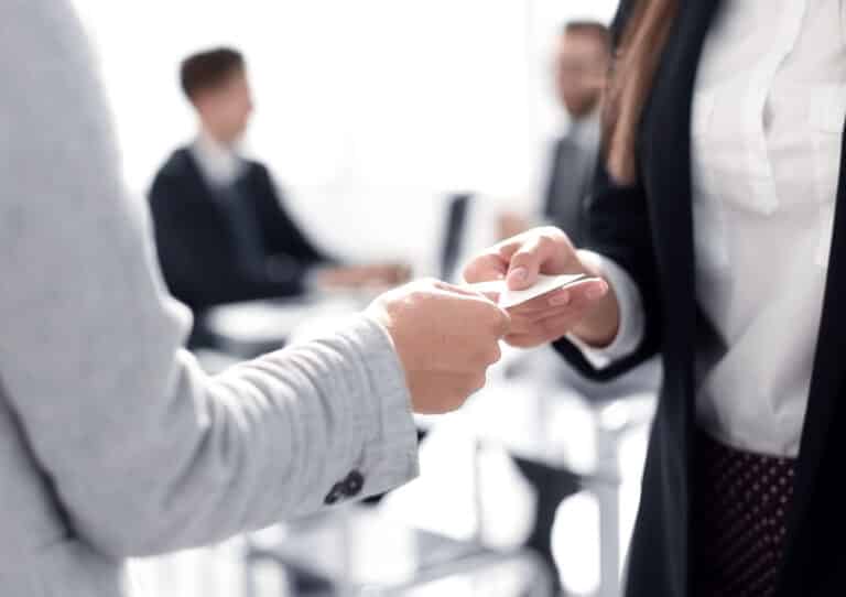 close up of two business woman exchanging business card