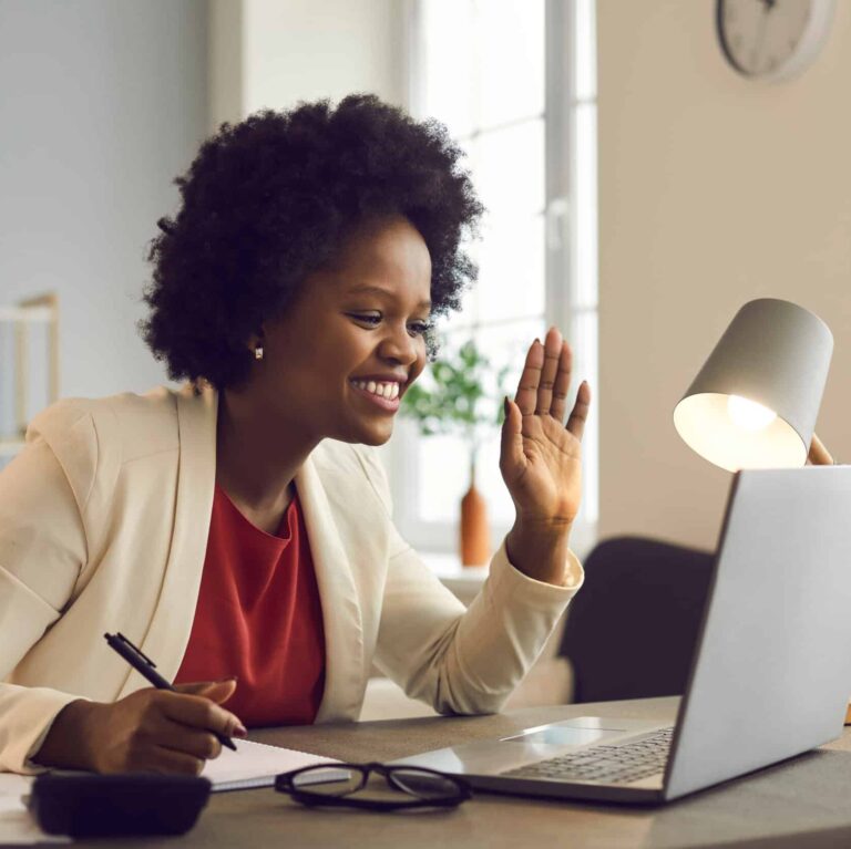 Friendly african american businesswoman holds an online meeting while sitting in the office