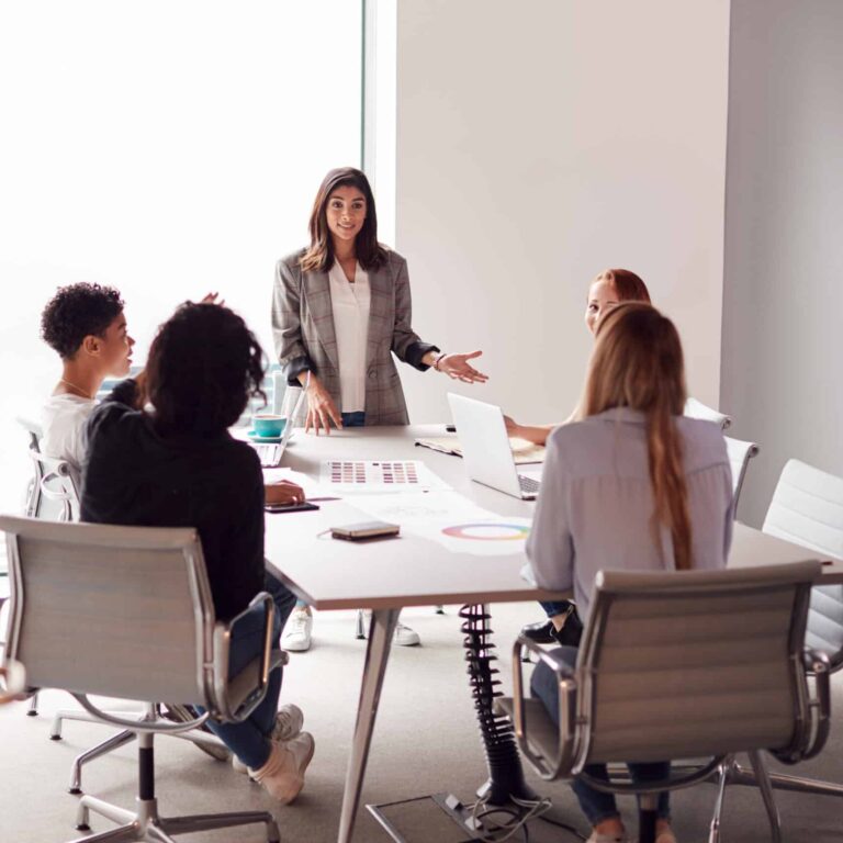 five professional women around a table