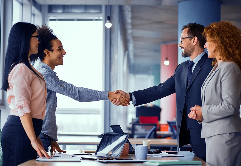 four business people meeting and shaking hands