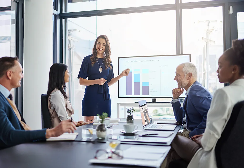 woman giving presentation and showing data to a group