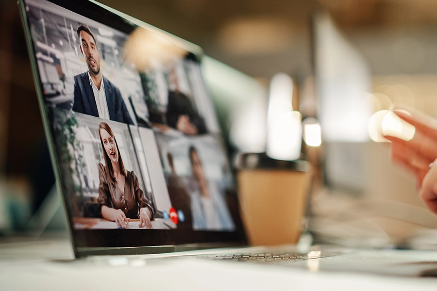 person in virtual meeting on laptop